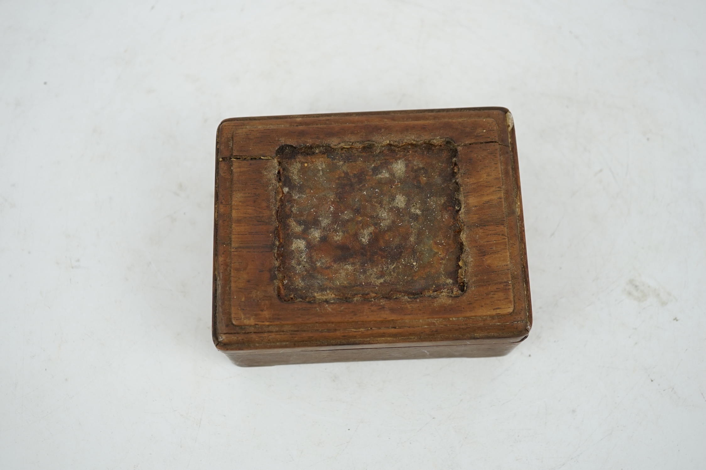 A Chinese pale celadon jade plaque, 17th/18th century, now inset into a hongmu box